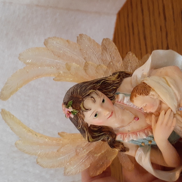 Pretty Angel holding a baby - Picture 2 of 4